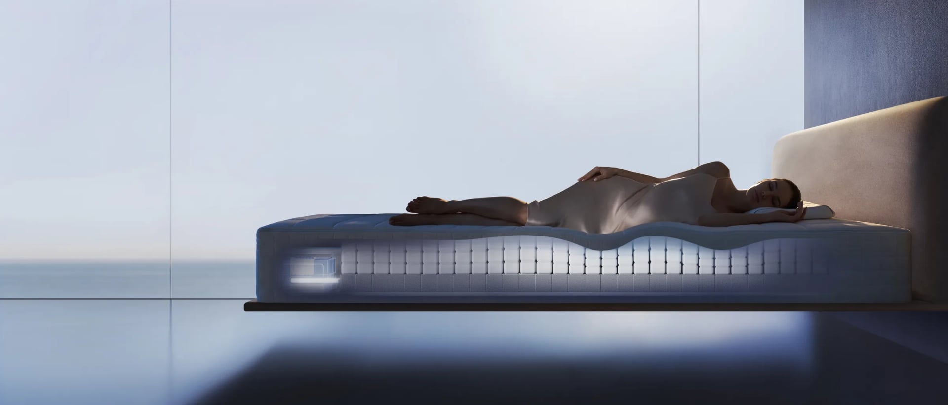 A woman asleep on a softly lit HEKA AI Mattress